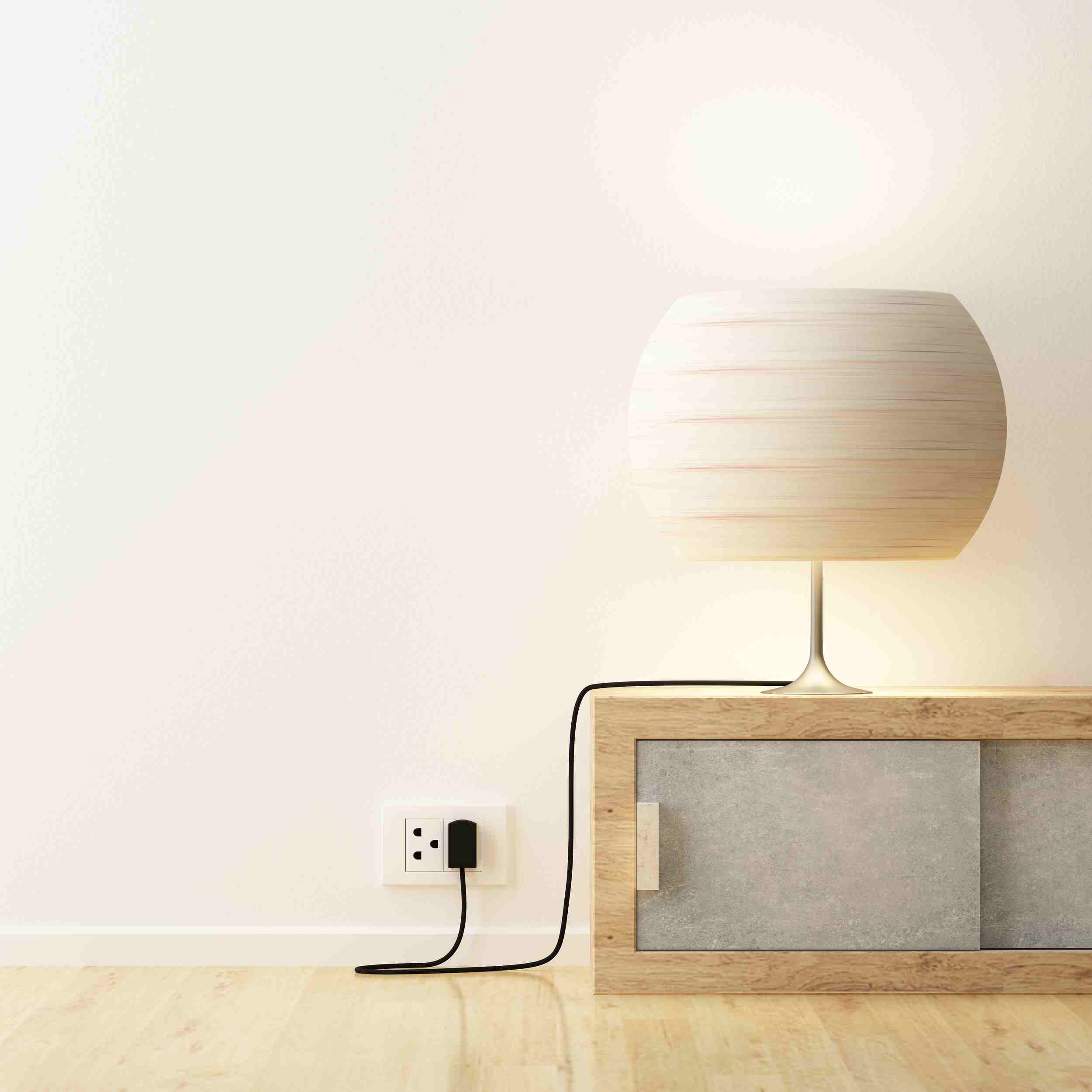 white lamp on low wood cabinet