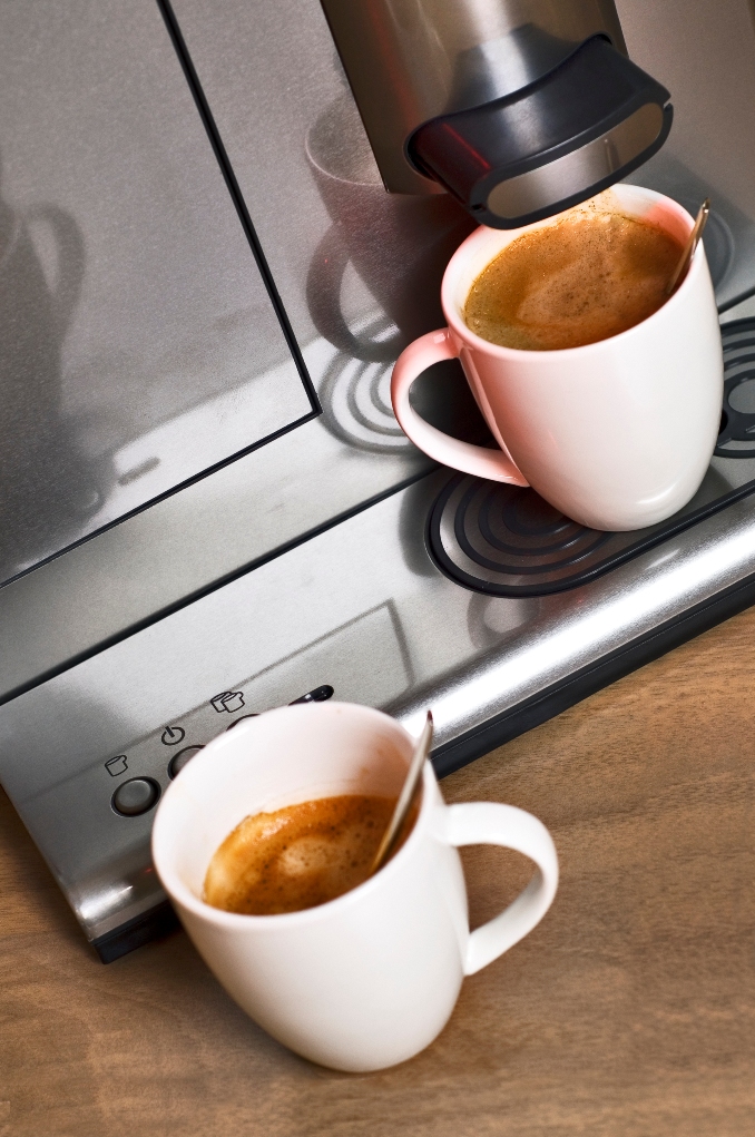 Modern, steel, pad coffee maker with two porcelain cups